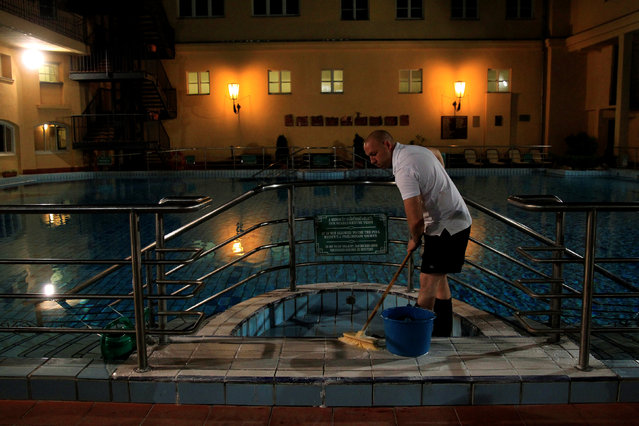 A worker cleans a pool at the Lukacs Bath in Budapest, Hungary July 6, 2016. (Photo by Bernadett Szabo/Reuters)
