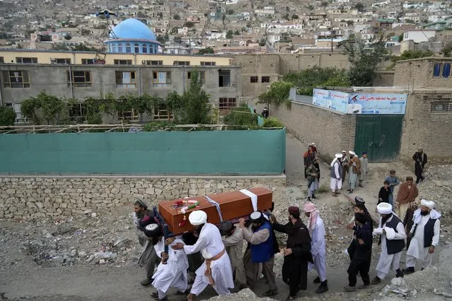 Mourners carry the body of a victim of a mosque bombing in Kabul, Afghanistan, Thursday, August 18. 2022. A bombing at a mosque in Kabul during evening prayers on Wednesday killed at least 10 people, including a prominent cleric, and wounded over two dozen, an eyewitness and police said. (Photo by Ebrahim Noroozi/AP Photo)