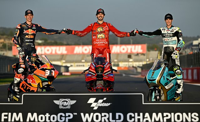 MotoGP world champion Ducati Italian rider Francesco Bagnaia (C) poses for pictures with Moto2 world champion Kalex Spanish rider Pedro Acosta (L) and Moto3 world champion Honda Spanish rider Jaume Masia at the end of the MotoGP Valencia Grand Prix at the Ricardo Tormo racetrack in Cheste, on November 26, 2023. Italy's Francesco Bagnaia enjoyed a dream day as he retained his MotoGP world title and crowned it with victory in the final race of the season in Valencia today. The 26-year-old Ducati rider had been assured of the championship when his sole rival Jorge Martin crashed early in the race. (Photo by Javier Soriano/AFP Photo)