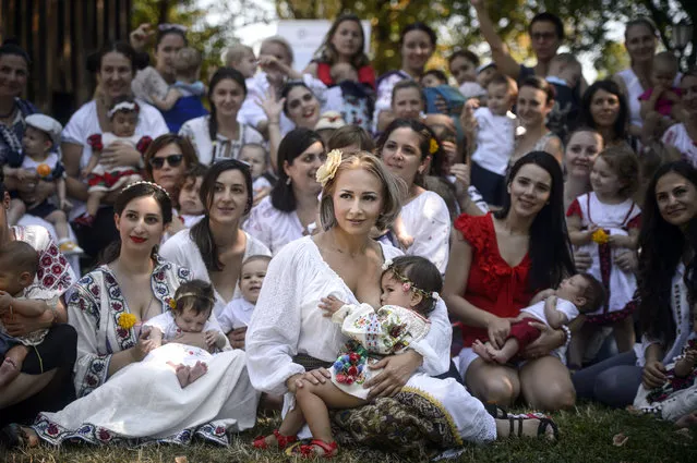 Women breastfeed their babies at an event promoting the freedom of mothers to breastfeed in public, during World Breastfeeding Week, at the Village Museum in Bucharest Romania, Saturday, August 6, 2016. (Photo by Andreea Alexandru/AP Photo)
