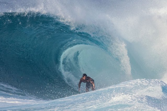 US surfer Barron Mamiya rides a wave in the North Shore of Oahu, Hawaii, on February 18, 2025. (Photo by Brian Bielmann/AFP Photo)