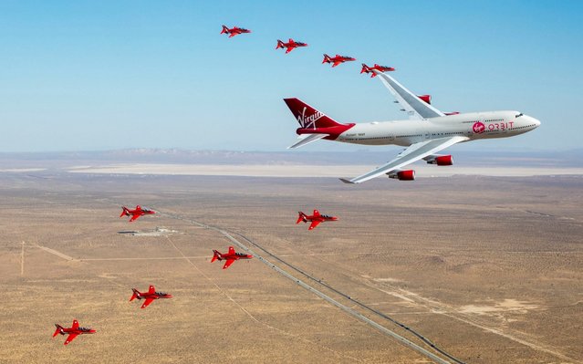 A handout picture provided by the British Ministry of Defence (MOD) shows Virgin Orbit “Cosmic Girl” launch aircraft flying in formation alongside the Red Arrows Hawk jets in Long Beach, California, USA, 02 October 2019. The Royal Air Force (RAF) and Virgin Orbit have selected the RAF pilot to be seconded to the company's ground-breaking small satellite launch programme. (Photo by Cpl Adam Fletcher/British Ministry of Defence /EPA/EFE/Rex Features/Shutterstock)