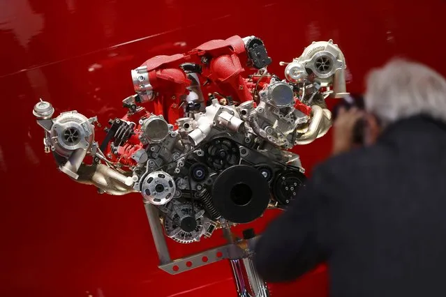 A visitor takes a picture of a Ferrari engine during the media day at the Frankfurt Motor Show (IAA) in Frankfurt, Germany September 16, 2015. (Photo by Kai Pfaffenbach/Reuters)