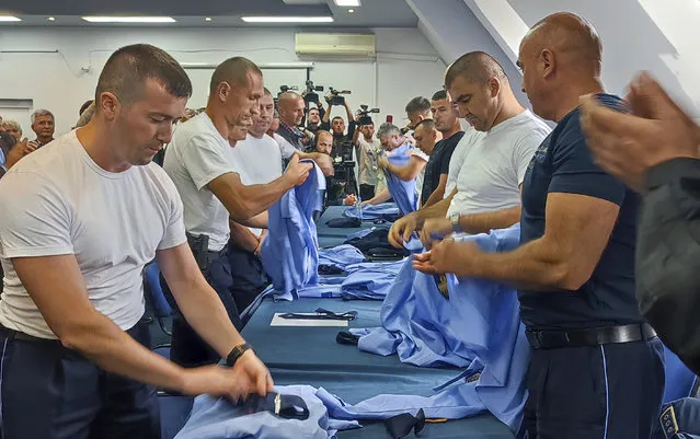 Serb police officers took off their uniforms in the town of Zvecan, Kosovo, Saturday, November 5, 2022. Representatives of the ethnic Serb minority in Kosovo on Saturday resigned from their posts in protest over the dismissal of a police officer who did not follow the government's decision on vehicle license plates. Earlier this week Pristina authorities dismissed a senior Serb police officer in northern Kosovo, where most of the ethnic Serbs live, who refused to respect the decision to change vehicle license plates in Kosovo to ones issued by Kosovo. (Photo by Bojan Slavkovic/AP Photo)