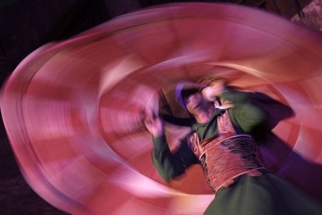 A dervish spins during a religious performance to mark the holy month of Ramadan at Sultan Qansuh al-Ghuri complex in Cairo, Egypt, Wednesday, March 12, 2025. (Photo by Amr Nabil/AP Photo)