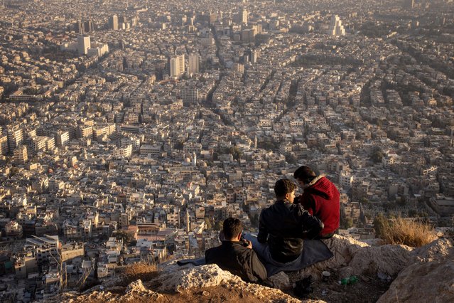People take photos as they look at the view over Damascus city on December 17, 2024 in Damascus, Syria. On December 8, rebel forces in Syria retook the capital and several other cities from longtime ruler Bashar al-Assad, who fled the country for Moscow. The fall of the Assad regime marks a new chapter for Syria, which has been mired in a multi-party civil war since 2011, sparked by the Arab Spring uprisings. (Photo by Chris McGrath/Getty Images)