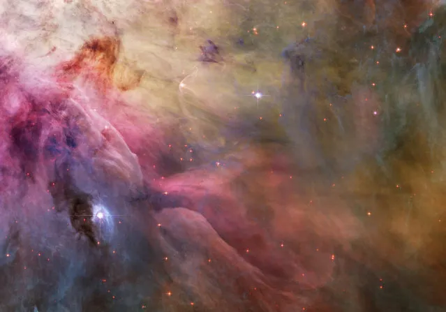 An aesthetic close-up of cosmic clouds and stellar winds featuring LL Orionis, interacting with the Orion Nebula flow. Adrift in Orion's stellar nursery and still in its formative years, variable star LL Orionis produces a wind more energetic than the wind from our own middle-aged Sun. (Photo by Reuters/NASA/ESA/Hubble Heritage Team)