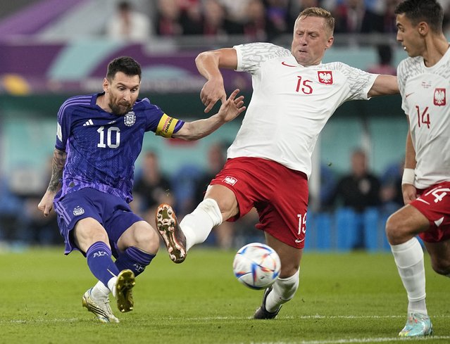 Poland's Kamil Glik, center, tries to block a shot from Argentina's Lionel Messi during the World Cup group C soccer match between Poland and Argentina at the Stadium 974 in Doha, Qatar, Wednesday, November 30, 2022. (Photo by Ariel Schalit/AP Photo)