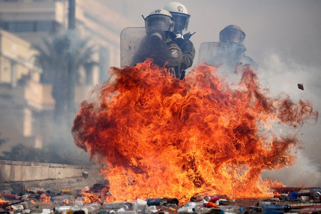 Riot police react to ignited Molotov cocktails thrown by demonstrators, at a protest near the Greek parliament, in Athens, Greece, on February 28, 2025. (Photo by Florion Goga/Reuters)