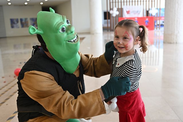 Healthcare workers working in the neonatal department, entertain premature babies by wearing costumes in Antalya, Turkiye on April 19, 2025. Healthcare workers working in a private hospital surprise babies by wearing the costumes of cartoon characters in the events organized to maintain their bond with children and make them happy. Leaving their hospital gowns aside, the health workers appear before children in the costumes of popular characters such as Mickey Mouse, Shrek, Superman, Spiderman and the Smurfs. (Photo by Orhan Cicek/Anadolu via Getty Images)