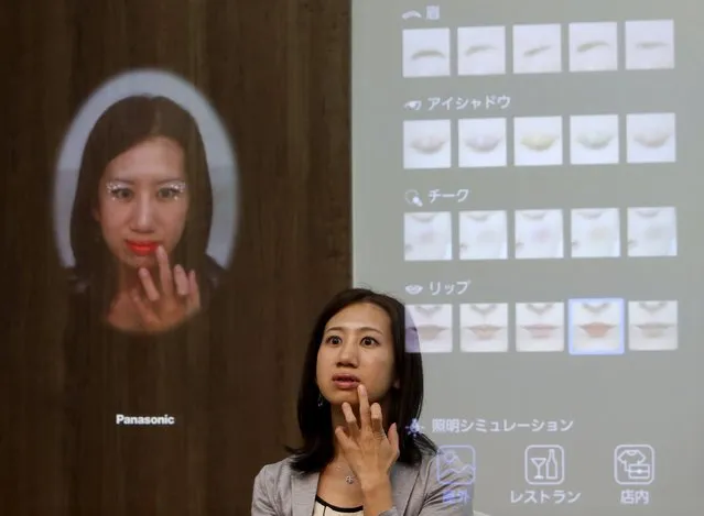 A woman is reflected in Panasonic Corp's interactive mirror, which is able to apply virtual makeup and detect skin condition, during a demonstration at CEATEC (Combined Exhibition of Advanced Technologies) JAPAN 2015 in Makuhari, Japan, October 6, 2015. Over 500 companies and organisations are exhibiting at CEATEC JAPAN 2015, which will be held until October 10. (Photo by Yuya Shino/Reuters)