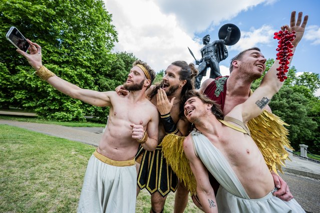 The Australian acrobatic troupe Head First Acrobats perform in front of the classical Greek statue of Achilles in Hyde Park in London on June 1, 2025. This is to launch their Greek myth themed show GODZ before its run at the Sadlers Wells Peacock theatre from 11-14 June. (Photo by Guy Bell/Rex Features/Shutterstock)