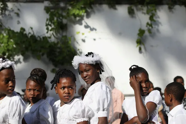Young girls take part in a Corpus Christi procession in Port-au-Prince, Haiti on June 15, 2017. (Photo by Andres Martinez Casares/AP Photo)