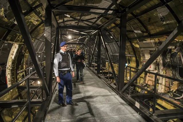 A military policeman stands guard in the reconstructed MH17 airplane after the presentation of the final report into the crash of July 2014 of Malaysia Airlines flight MH17 over Ukraine, in Gilze Rijen, the Netherlands, October 13, 2015. (Photo by Michael Kooren/Reuters)