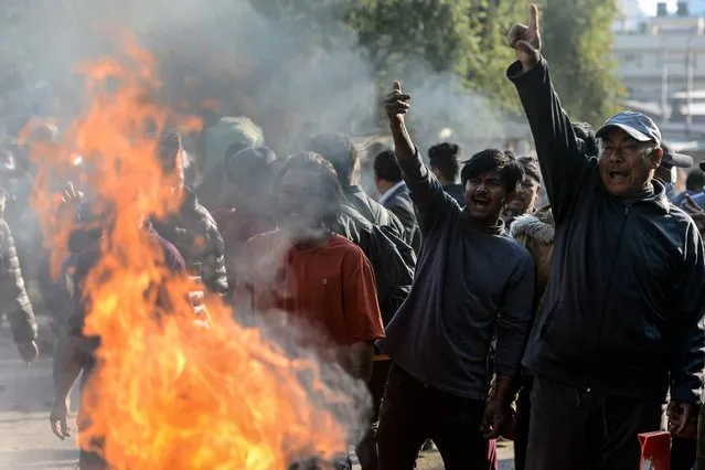 Landless squatters chant anti-government slogans and scuffle with police as they protest the decision of the authorities to vacate the landless squatters residing in various parts of the city, during a demonstration in Kathmandu on November 28, 2022. (Photo by Prakash Mathema/AFP Photo)