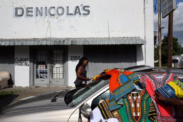 A woman shops for African shirts near the Triple S convenience store where Alton Sterling was shot dead by police in Baton Rouge, Louisiana, U.S. July 16, 2016. (Photo by Joe Penney/Reuters)