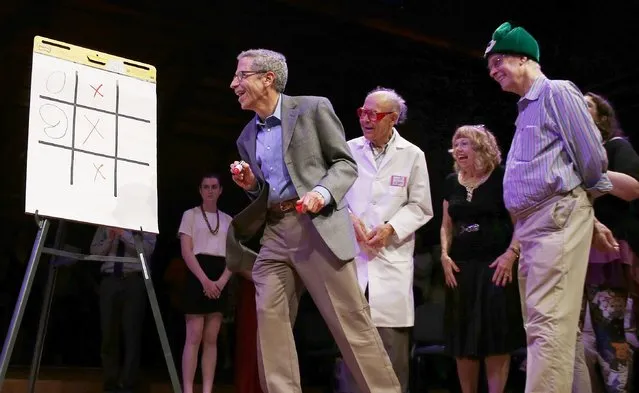 Nobel laureates Rich Roberts (physiology or medicine, 1993), right, Dudley Herschbach (chemistry, 1986) third from right, and Eric Maskin (economics, 2007), second from left, compete in a game of “tic-toc-toe” with a brain surgeon during the Ig Nobel award ceremonies at Harvard University in Cambridge, Mass., Thursday, September 22, 2016. (Photo by Michael Dwyer/AP Photo)