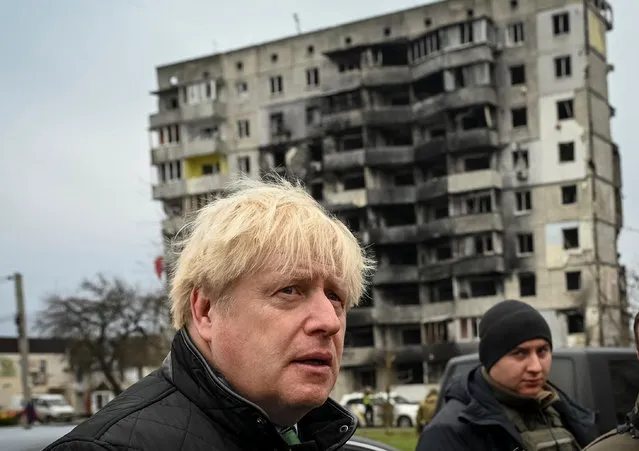 Former British Prime Minister Boris Johnson visits the town of Borodianka, heavily damaged during Russia's invasion of Ukraine, outside of Kyiv, Ukraine on January 22, 2023. (Photo by Viacheslav Ratynskyi/Reuters)