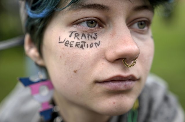 A demonstrator attends a protest demanding a law to protect the rights of the transgender community outside the parliament Bundestag building in Berlin, April 12, 2024. German lawmakers went on to approve legislation that will make it easier for transgender, intersex and nonbinary people to change their name and gender in official records. (Photo by Ebrahim Noroozi/AP Photo)