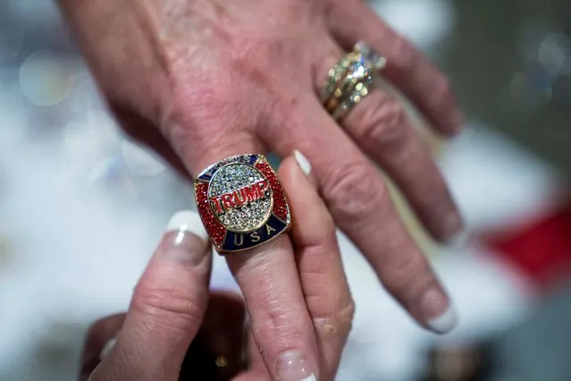 A woman tries on a “Trump” ring at a merchandise booth at the Conservative Political Action Conference (CPAC) at Gaylord National Convention Center in National Harbor, Maryland on March 3, 2023. (Photo by Sarah Silbiger/Reuters)