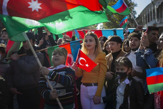 Hundreds of Azerbaijani people carrying the flags of Azerbaijan and Turkey, stage a march as they celebrate the National Flag Day and Shusha's liberation from occupation, on November 09, 2020 in Ganja, Azerbaijan. (Photo by Arif Hudaverdi Yaman/Anadolu Agency via Getty Images)
