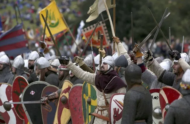 Re-enactors participate in a re-enactment of the Battle of Hastings, commemorating the 950th anniversary of the battle, in Battle, Britain October 15, 2016. (Photo by Neil Hall/Reuters)