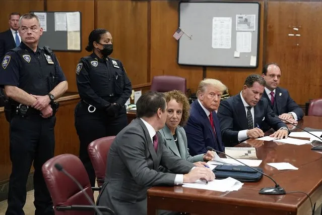 Former U.S. President Donald Trump sits at the defense table with his defense team in a Manhattan court during his arraignment on April 4, 2023, in New York City. Trump was arraigned during his first court appearance today following an indictment by a grand jury that heard evidence about money paid to adult film star Stormy Daniels before the 2016 presidential election. With the indictment, Trump becomes the first former U.S. president in history to be charged with a criminal offense. (Photo by Seth Wenig-Pool/Getty Images)