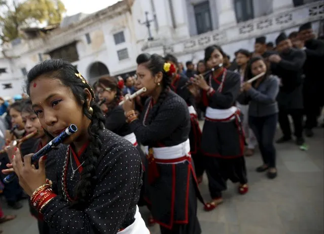 Participants from Newar community in traditional attire, play flutes in front of the ancient palace which was damaged during the earthquake while celebrating Newari New Year parade that falls during the Tihar festival, also called Diwali, in Kathmandu, Nepal November 12, 2015. (Photo by Navesh Chitrakar/Reuters)