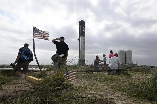 Space fans walk the dunes as workers prepare the SpaceX's Starship spacecraft and Super Heavy rocket as they attempt to schedule another launch launch from Starbase after it was scrubbed on April 17, 2023. (Photo by Jonathan Newton/The Washington Post)