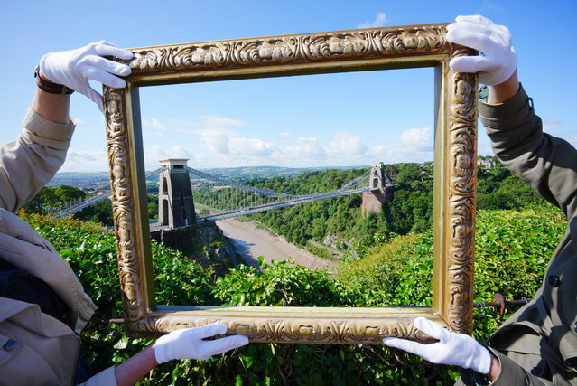 Bristol Museum & Art Gallery representatives on Monday, June 23, 2025 hold an empty frame against Avon Gorge in Bristol, which was painted by JMW Turner in The Rising Squall, Hot Wells, from St Vincent's Rock, Bristol (1792). A fundraising campaign has been launched to bring one of the earliest works by Turner back to the city of Bristol where the artist painted it when he was 17 years old. Bristol Museum & Art Gallery is now keen to acquire the work, which is believed to be the only oil painting Turner made of the city. (Photo by Ben Birchall/PA Images via Getty Images)