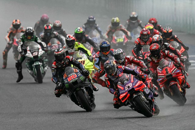 Prima Pramac Racing's Spanish rider Jorge Martin (centre R) leads the pack during the MotoGP Thailand Grand Prix at the Buriram International Circuit in Buriram on October 27, 2024. (Photo by Lillian Suwanrumpha/AFP Photo)
