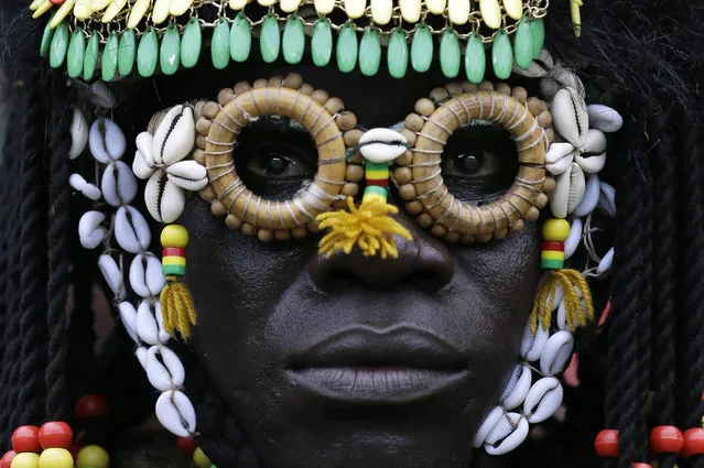 A Burkina Fass soccer fan watches the African Cup of Nations Group A soccer match between Equatorial Guinea and Burkina Faso in Bata, Equatorial Guinea, Wednesday, January 21, 2015. (Photo by Themba Hadebe/AP Photo)