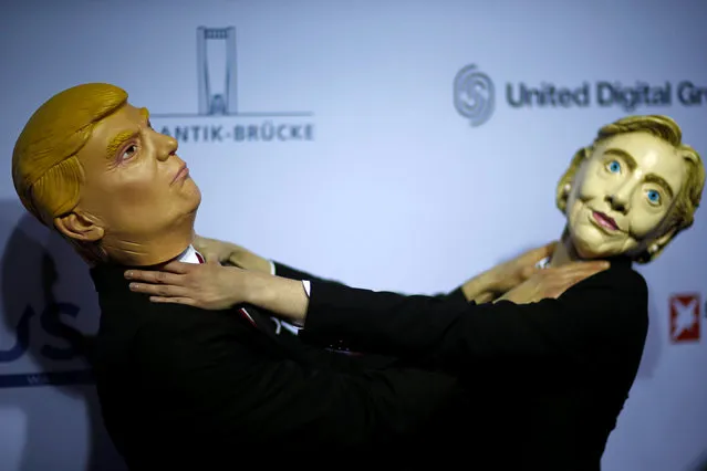 Actors wearing Donald Trump and Hillary Clinton masks pretend to choke each other in Berlin, Germany, November 8, 2016. (Photo by Axel Schmidt/Reuters)