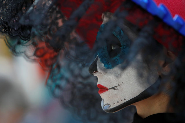 A participant with a face painted as popular Mexican figure “Catrina” attends the Day of the Dead event at a National house for Mexican fans in central Moscow, a host city for the 2018 FIFA World Cup, Russia June 29, 2018. (Photo by Sergei Karpukhin/Reuters)