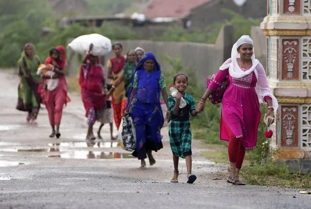 People are evacuated from Jakhau in Kutch district, in the Western Indian state of Gujarat, Wednesday, June 14, 2023. Cyclone Biparjoy was packing maximum sustained winds of 180 kilometers per hour (111 mph), according to the India Meteorological Department. It is projected to make landfall near Jakhau port in the Kutch district of India's Gujarat state. (Photo by Ajit Solanki/AP Photo)