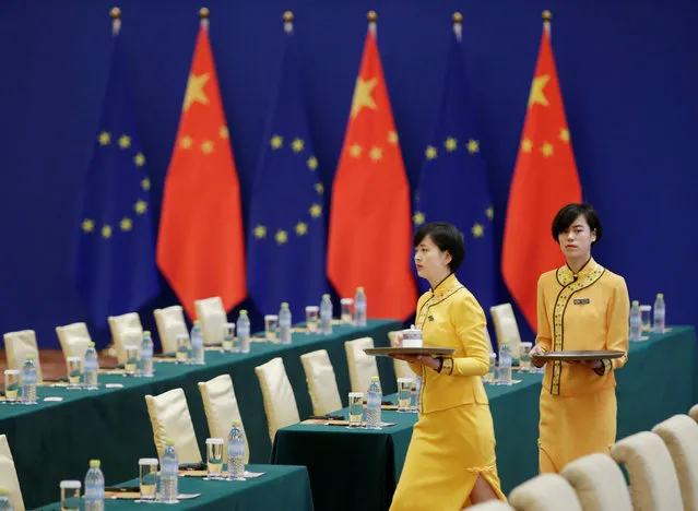 Attendants prepare for the EU-China High-level Economic Dialogue at Diaoyutai State Guesthouse in Beijing, China, June 25, 2018. (Photo by Jason Lee/Reuters)