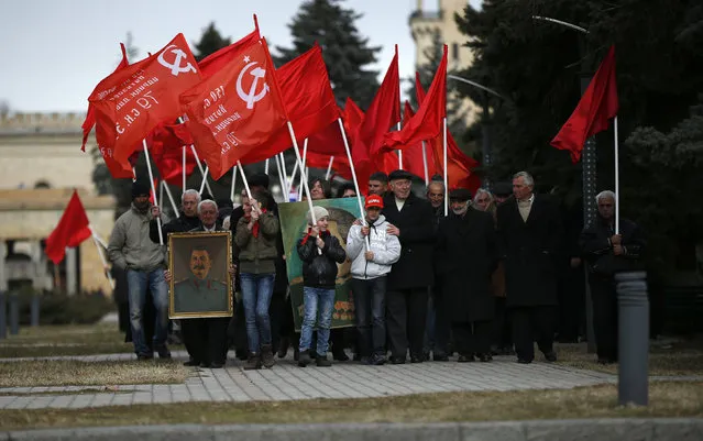 People carry flags and portraits of Soviet leader Joseph Stalin while marching during a rally to mark Stalin's birthday anniversary at his hometown in Gori, Georgia, December 21, 2015. (Photo by David Mdzinarishvili/Reuters)