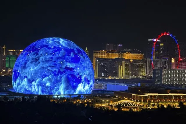 The MSG Sphere illuminates the Las Vegas skyline with a display to celebrate Independence Day as the Exosphere is fully lit up for the first time, as seen from the Metropolis, on Tuesday, July 4, 2023. (Photo by L.E. Baskow/Las Vegas Review-Journal via AP Photo)