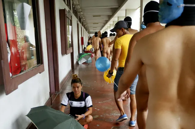 Students belonging to a fraternity at the University of the Philippines, the country's premier state university, run naked around the campus to condemn last week's burial of the late Philippine dictator Ferdinand Marcos at the Heroes' Cemetery Friday, November 25, 2016 in suburban Quezon city northeast of Manila, Philippines. Long-dead Marcos was buried last Friday at the country's Heroes' Cemetery in a secrecy-shrouded ceremony, a move approved by President Rodrigo Duterte that infuriated supporters of the “people power” revolt that ousted Marcos three decades ago. (Photo by Bullit Marquez/AP Photo)