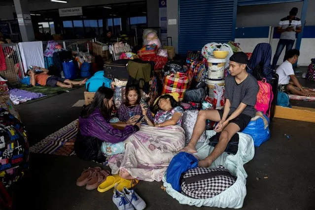 Stranded passengers at the Manila North Port take shelter at the terminal amid cancelled trips due to Typhoon Doksuri, in Manila, Philippines on July 25, 2023. (Photo by Eloisa Lopez/Reuters)