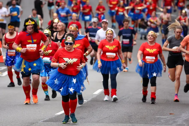 Participants dressed as Wonder Woman run at the start of the annual City to Surf fun run in Sydney on August 13, 2023. (Photo by David Gray/AFP Photo)
