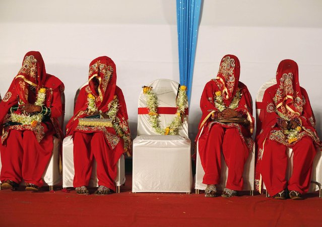Muslim brides wait for their wedding ceremonies to start during a mass marriage ceremony in Mumbai February 15, 2015. A total of 51 Muslim couples on Sunday took wedding vows during the mass marriage ceremony organised by a Muslim voluntary organisation, organisers said. (Photo by Shailesh Andrade/Reuters)