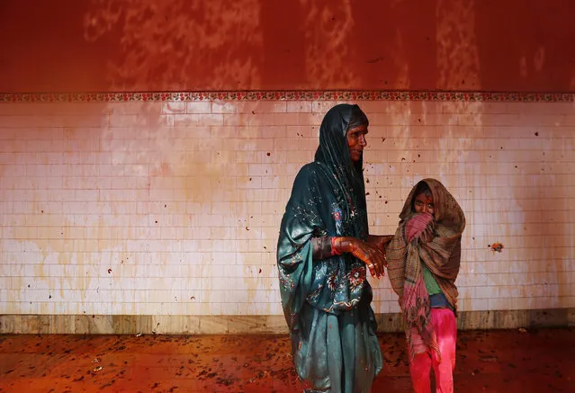 A woman and her daughter are daubed in colours as they stand after participating in “Huranga” at Dauji temple, near the northern Indian city of Mathura, March 7, 2015. (Photo by Adnan Abidi/Reuters)