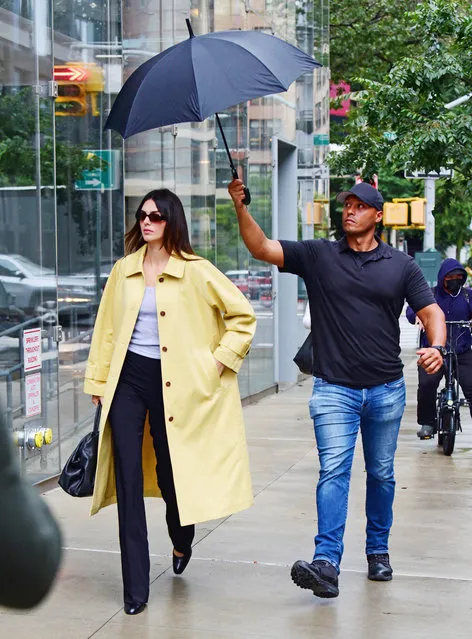 American model Kendall Jenner wears a yellow trench coat as she steps out on a rainy day in NYC on September 18, 2023. (Photo by The Mega Agency)