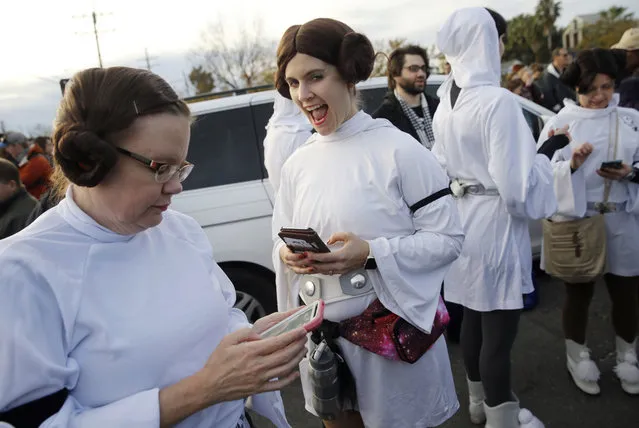 Members of the Krewe of Chewbacchus, a Mardi Gras Krewe, dressed as Princess Leia, use their smart phones at the start of a parade in honor of actress Carrie Fisher, who played Leia in the “Star Wars” movie series, in New Orleans, Friday, December 30, 2016. Fisher died on Dec. 27, 2016, at the age of 60. (Photo by Gerald Herbert/AP Photo)
