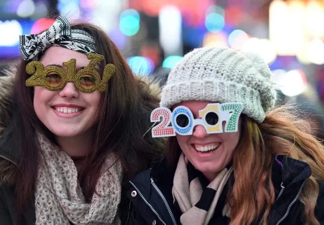 People gather in Times Square to celebrate New Year's Eve in New York on December 31, 2016. (Photo by Angela Weiss/AFP Photo)