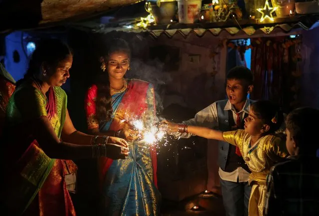 People light fireworks to celebrate Diwali, the Hindu festival of lights, in New Delhi, India on November 12, 2023. (Photo by Anushree Fadnavis/Reuters)