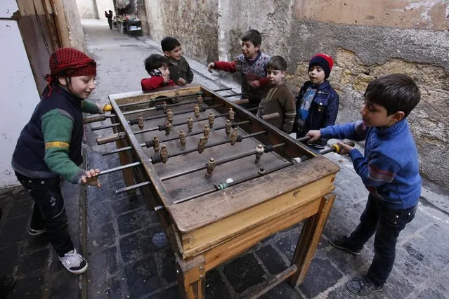 Children play table football in Old Aleppo, December 15, 2013. (Photo by Molhem Barakat/Reuters)