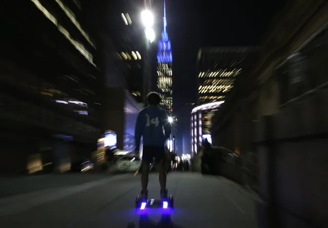 In this October 21, 2015 file photo, a young man rides a hoverboard down a Manhattan street toward the Empire State Building in  New York. The U.S. Consumer Product Safety Commission said the Friday, February 19, 2016  that the hoverboards can be a fire hazard and will go after companies that make, sell, import or distribute hoverboards that don't meet safety standards. (Photo by Kathy Willens/AP Photo)
