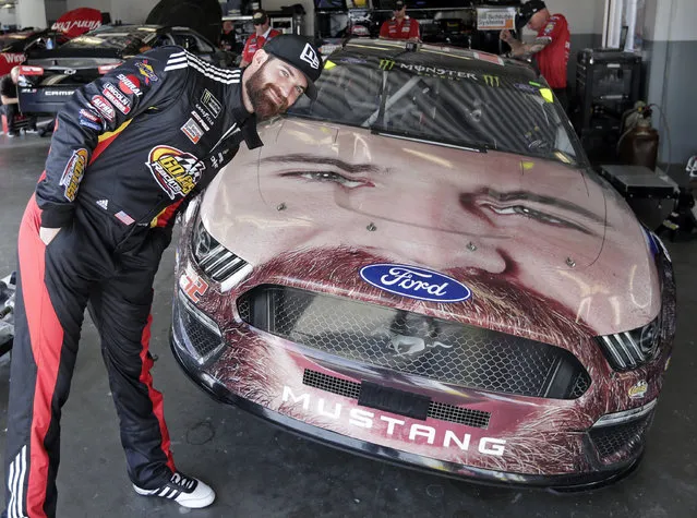 Corey LaJoie leans over the hood of his car with a likeness of him painted on the front end before a practice session for the NASCAR Daytona 500 auto race at Daytona International Speedway, Friday, February 15, 2019, in Daytona Beach, Fla. (Photo by John Raoux/AP Photo)